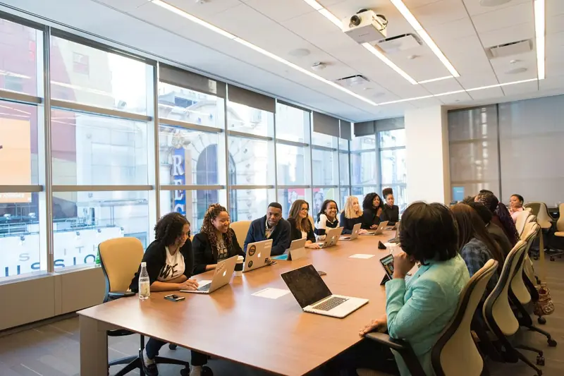 Staff working together at a long office table