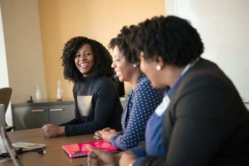 Colleagues talking around a meeting table